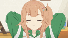a girl with brown hair and a green jacket has her eyes closed and a heart shaped hair clip in her hair