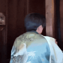 a man wearing a blue shirt that says hawaii on it