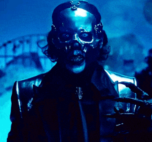 a man with a skull on his head and a claw on his hand