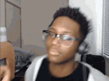 a blurry picture of a man wearing glasses and headphones .