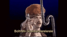 a man is holding a pipe in his mouth with the words boitoshi guerelelerelerele written below him