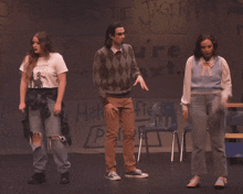 three people stand on a stage in front of a wall that says the jager