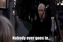 a man is pointing at a woman and saying nobody ever goes in .