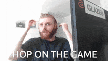 a man with a beard is standing in front of a glazed tv