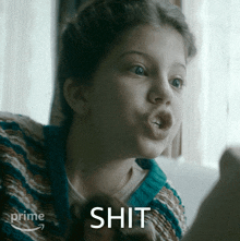 a little girl is making a funny face and the word shit is on the bottom