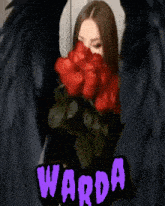 a woman is holding a bouquet of red roses in front of her face and the name warda is on the bottom