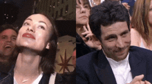 a man and a woman are sitting in a crowd and the woman is making a funny face