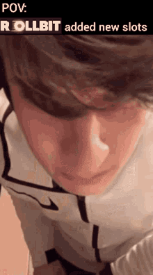 a close up of a person 's face with the words `` rollbit added new slots '' written on it .