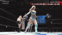 a woman in a wrestling ring with the word stardom on the top
