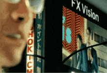 a man stands in front of a fx vision sign