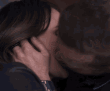 a man touches a woman 's face in a close up