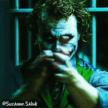 a close up of the joker 's face with the name suzanne sabik on the bottom