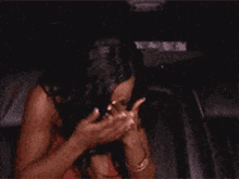 a woman covering her face with her hands in a blurry photo