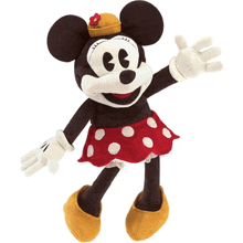 a stuffed minnie mouse wearing a red polka dot skirt