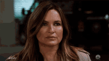 a close up of a woman 's face with the nbc logo on the bottom right