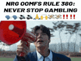 a man is holding a megaphone in front of a sign that says nrg oomfs rule 380 never stop gambling !!!