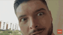 a close up of a man 's face with a subscribe button on the bottom