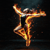 a woman in a black leotard is surrounded by fire
