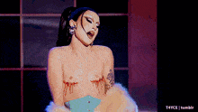 a naked woman with blood dripping from her breasts is on a stage ..