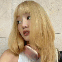 a woman with blonde hair is wearing a white tank top with the word cool written on the bottom