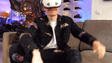 a man wearing a virtual reality headset is sitting in a chair