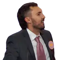 a man in a suit and tie has a badge on his neck that says ' i 'm a candidate '