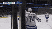 a hockey player with the number 74 on his jersey is on the ice
