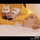 a person is laying in bed with stuffed animals and the caption says " cuz i 'm so hungry "