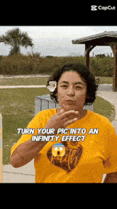 a woman in a yellow shirt is blowing a kiss