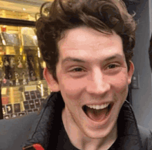 a young man with his mouth open is smiling