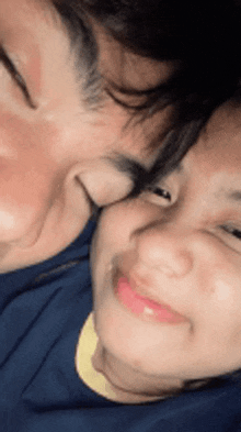 a man and a woman are laying next to each other .