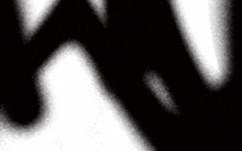 a black and white background with a swirl of white dots on it .
