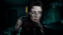 a blurred image of a woman talking on a phone in a dark room .
