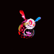 a colorful monster with a smaller monster behind it on a black background
