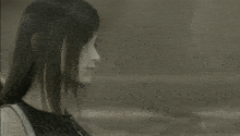 a black and white photo of a woman with long dark hair