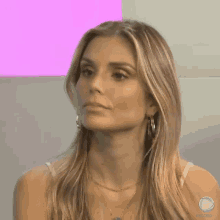 a woman wearing hoop earrings and a necklace with the word record on the bottom