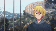 a boy with yellow hair and blue eyes stands in front of a building