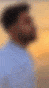 a blurry picture of a man with a beard and a hat