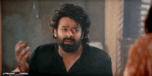 a man with a beard is making a funny face with the words pranay and varma below him