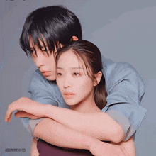 a man and a woman are hugging each other with the name jingmyeoon on the bottom right