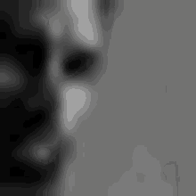 a black and white photo of a man 's face .