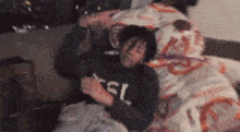 a man is laying on a bed with his head on a pillow and his arms outstretched .