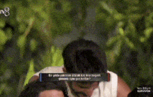 a man and a woman are hugging each other in front of a tree .