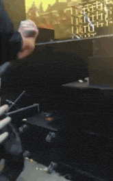 a man is holding a gun in front of a screen that says ' a ' on it