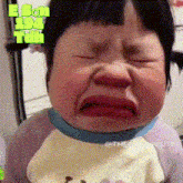 a baby making a funny face with the words e son 194 tun behind her