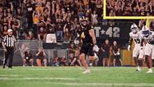 a football game is being played in front of a banner that says kansas