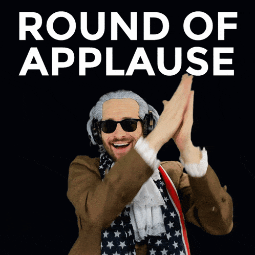 a man in an american flag costume is giving a high five in front of a round of applause sign