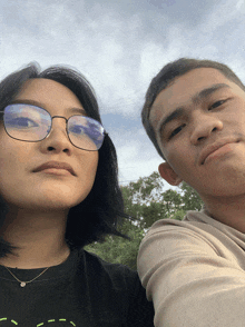 a man and a woman are posing for a picture