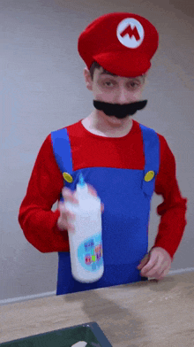a man dressed in a mario costume is holding a bottle of glue