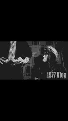 a black and white photo of a man and a woman with the word vlog on the bottom right corner .
